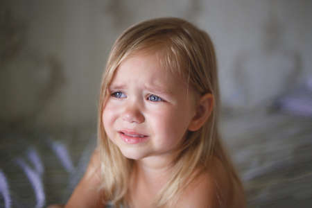 portrait of a little crying girl.の写真素材