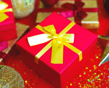 gift boxes with bow on red-gold background.