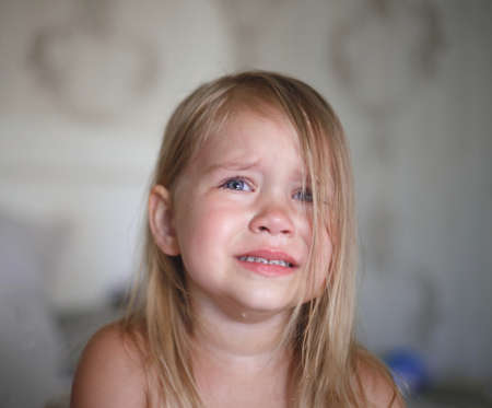 portrait of a little crying girl.の写真素材