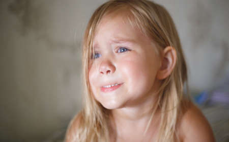 portrait of a little crying girl.の写真素材