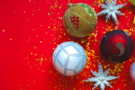 Beautiful Christmas balls and stars on a red background with sparkles.の写真素材