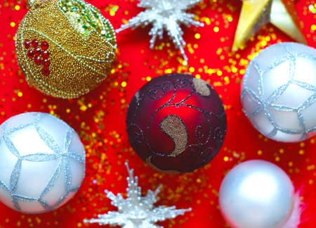 Beautiful Christmas balls and stars on a red background with sparkles.の写真素材