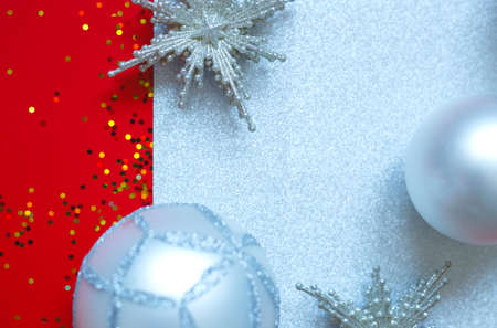Beautiful Christmas balls and stars on a red background with sparkles.の写真素材