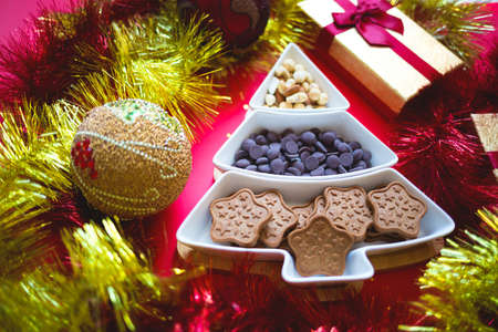 Christmas tree dish with nuts, chocolate and gingerbread cookiesの写真素材