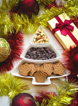 Christmas tree dish with nuts, chocolate and gingerbread cookiesの写真素材
