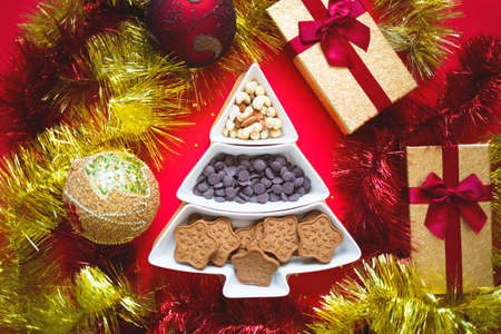 Christmas tree dish with nuts, chocolate and gingerbread cookies.の写真素材