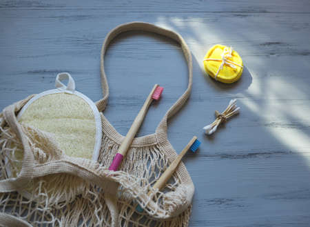 zero waste concept. bamboo toothbrushes and sticks, reusable discs, loofah washcloth.の写真素材