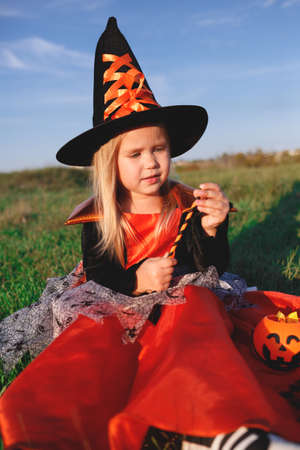 little girl dressed as a witch celebrates halloween.の写真素材