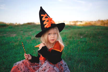 little girl dressed as a witch celebrates halloweenの写真素材