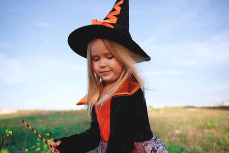 little girl dressed as a witch celebrates halloween.の写真素材