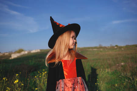 little girl dressed as a witch celebrates halloween.の写真素材