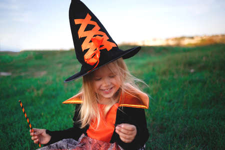 little girl dressed as a witch celebrates halloween.の写真素材
