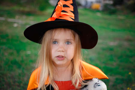 little girl dressed as a witch celebrates halloween.の写真素材