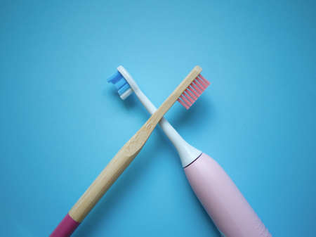 two ultrasonic electric toothbrushes on a blue background.の写真素材