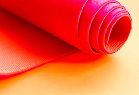 bright pink ultramarine yoga mat on orange background.の写真素材
