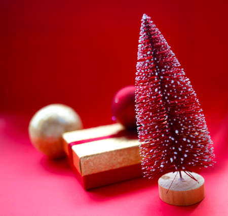 christmas tree and gifts on bright red background.の写真素材
