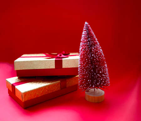 christmas tree and gifts on bright red backgroundの写真素材