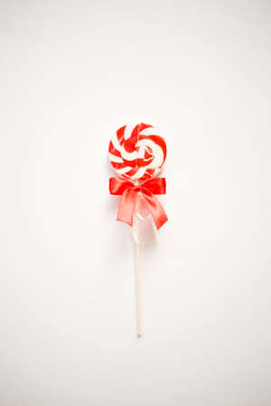 bright sweet christmas lollipop on white background.の写真素材