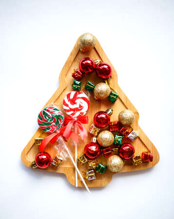 beautiful wooden christmas tree with garland and ornaments on white background.の写真素材