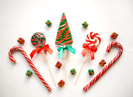 bright sweet christmas lollipops on white background.の写真素材