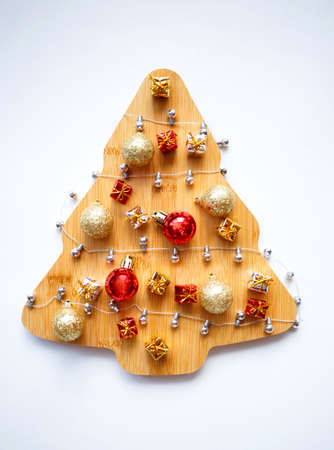 beautiful wooden christmas tree with garland and ornaments on white background.の写真素材
