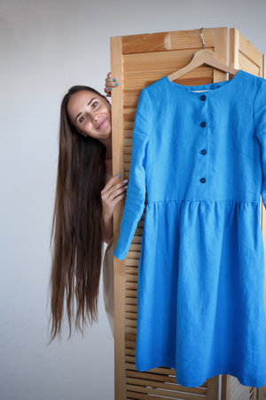 portrait of a young beautiful seamstress in blue dress.の写真素材