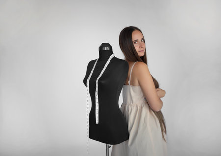 young beautiful seamstress and manikin at her workplace.の写真素材
