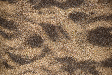 sand and stones on the beach. great background for design.の写真素材