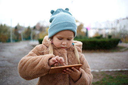 little cute girl playing mobile phone.の写真素材