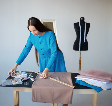 young beautiful seamstress and manikin at her workplace.の写真素材