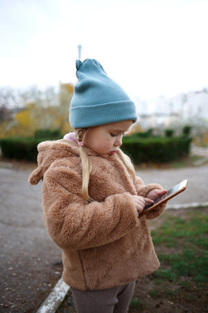 little cute girl playing mobile phone.の写真素材