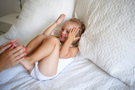 little girl covered her face with her hands. selective focusの写真素材