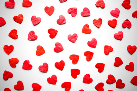 bright red hearts confetti on white background