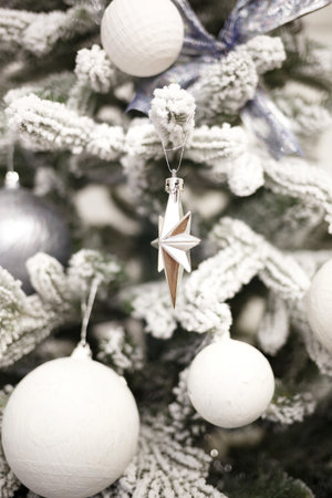 Christmas tree with white and silver balls and garlands.の写真素材