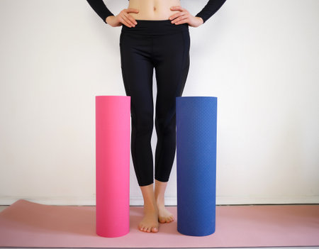 girl holding a pink and blue sports mat.の写真素材
