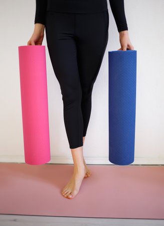 girl holding a pink and blue sports mat.の写真素材