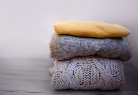 warm cozy sweaters in ultimate gray and illuminating on a gray background.の写真素材