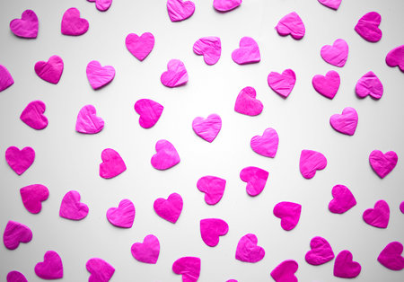 pink hearts confetti on white background.の写真素材