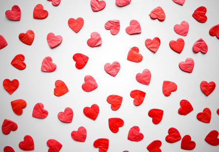 red hearts confetti on white background.の写真素材
