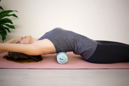 young woman doing exercises on a massage roller.の写真素材