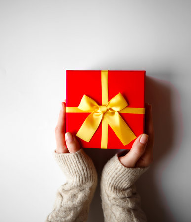 hands hold a gift on a white background.の写真素材