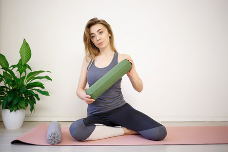 young woman doing exercises on a massage roller.の写真素材