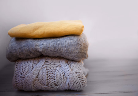 warm cozy sweaters in ultimate gray and illuminating on a gray background.の写真素材