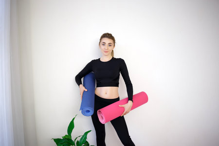 girl holding a pink and blue sports mat.の写真素材