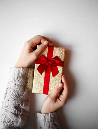 hands hold a gift on a white backgroundの写真素材