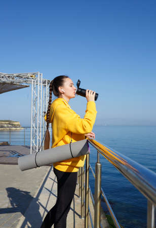 young woman doing sports outdoors by the sea.の写真素材