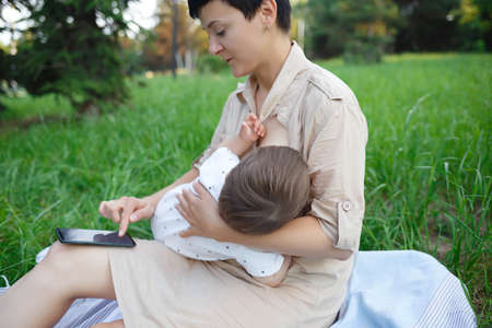 baby boy sucking milk from mothers breast. Portrait of mom and baby. Concept of healthy and natural...
