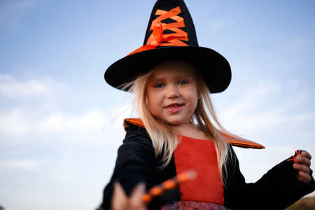 little cute girl dressed as a witch celebrates halloween.の写真素材