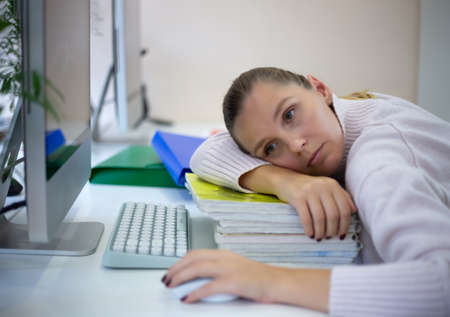 young woman is sad at the workplace. office work concep.の写真素材