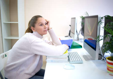 young woman is sad at the workplace. office work concep.の写真素材